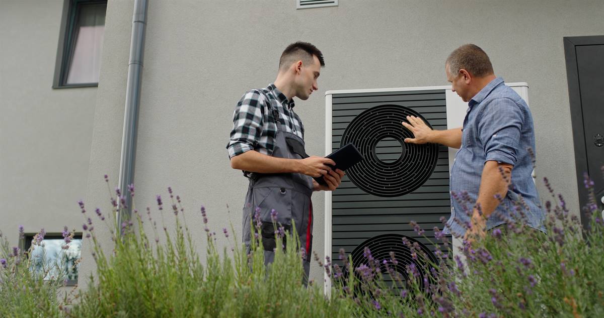 GreenShield technician reviewing heat pump options with an East Meadow, NY homeowner