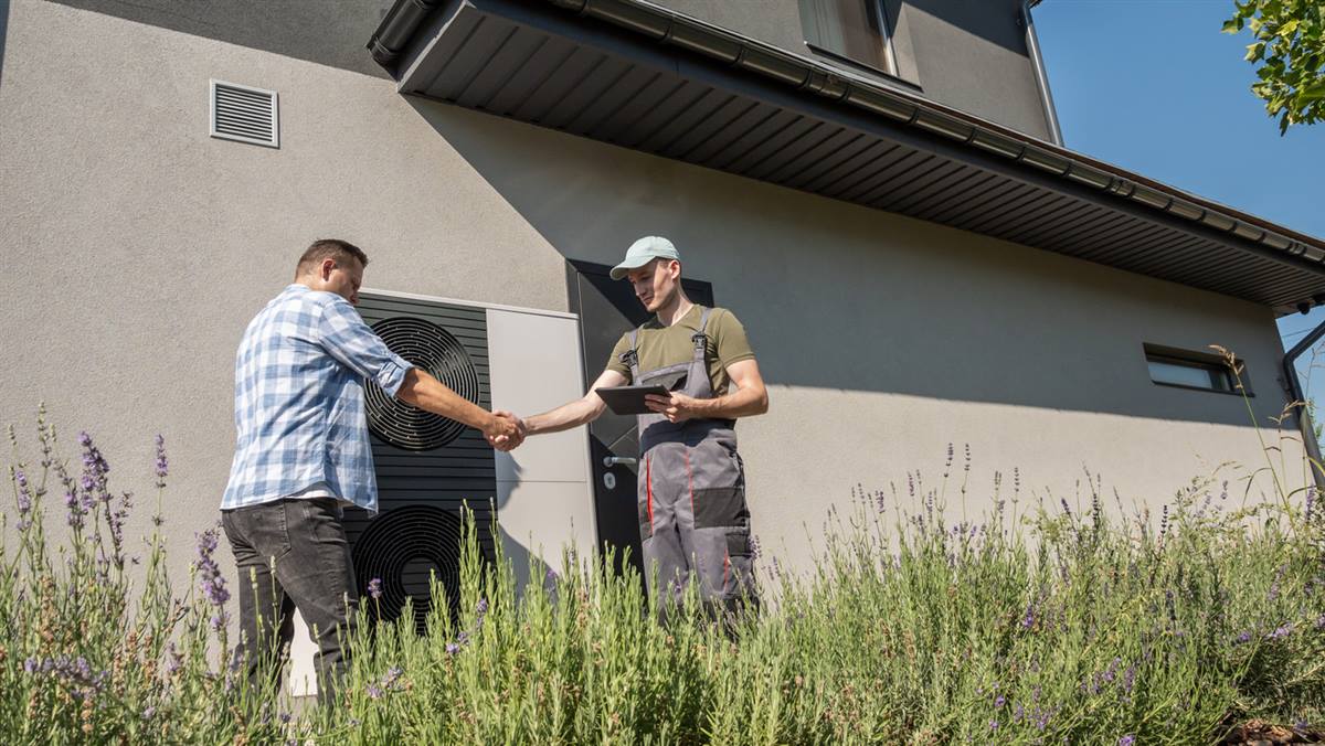 Homeowner and installer agreeing on an oil to heat pump conversion plan